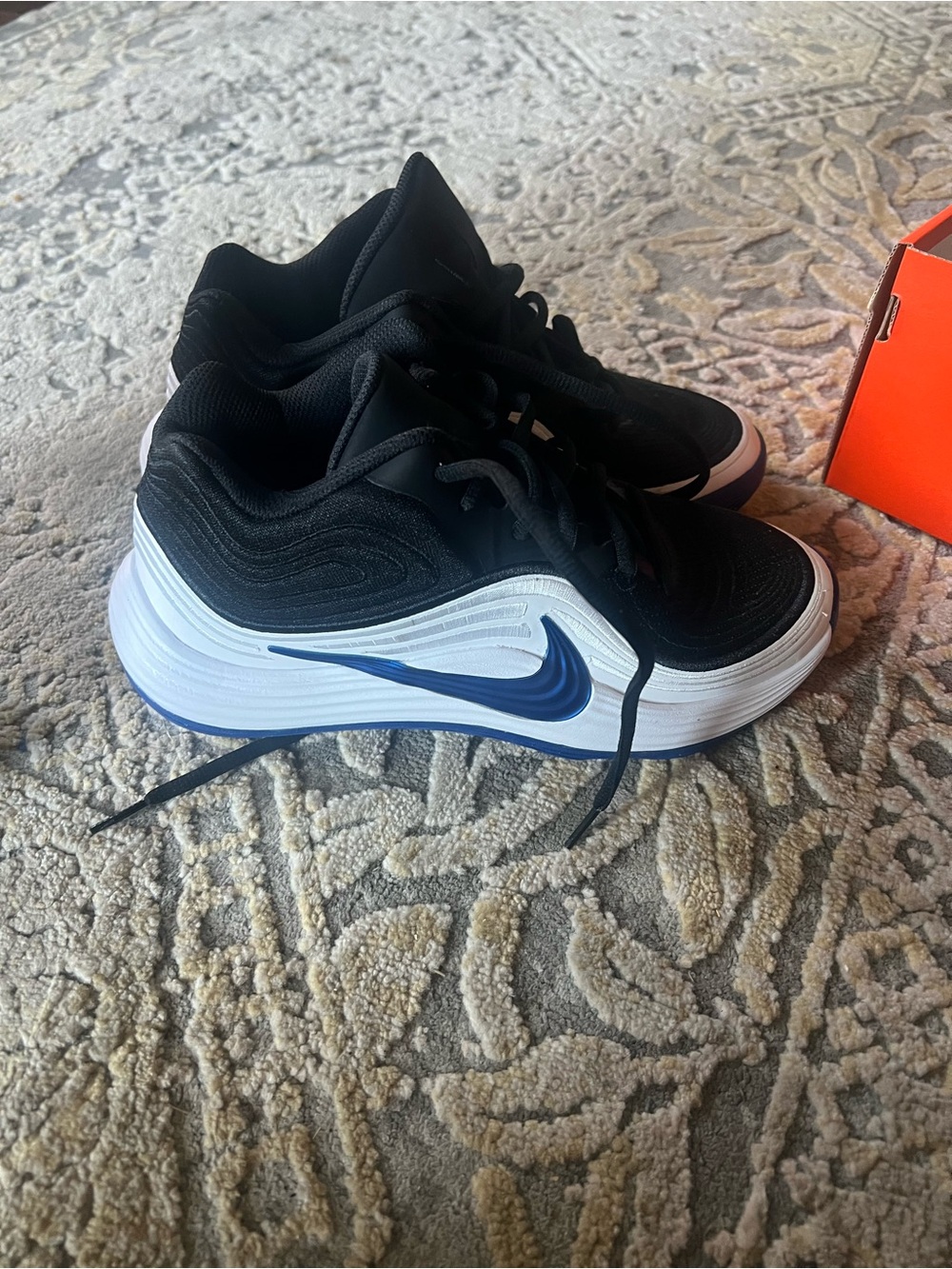 Nike Kids Black and White Sneakers with Blue Swoosh Accent